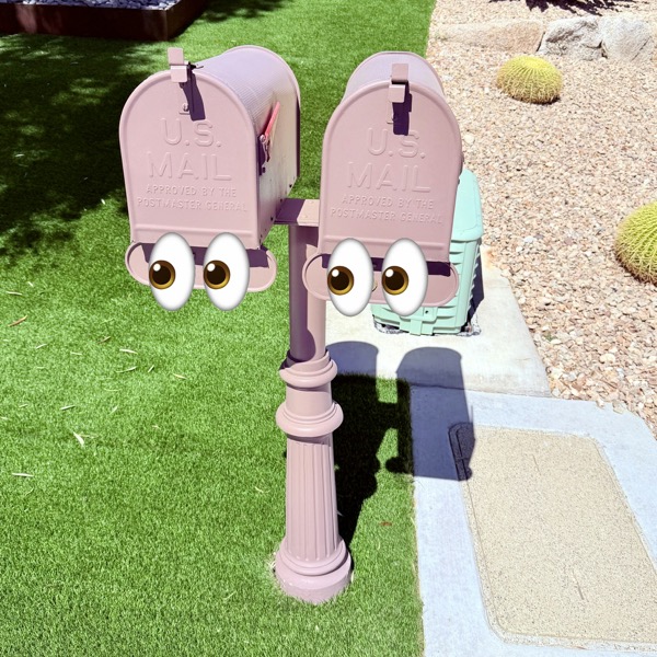two USPS mailbox mounted on a single post